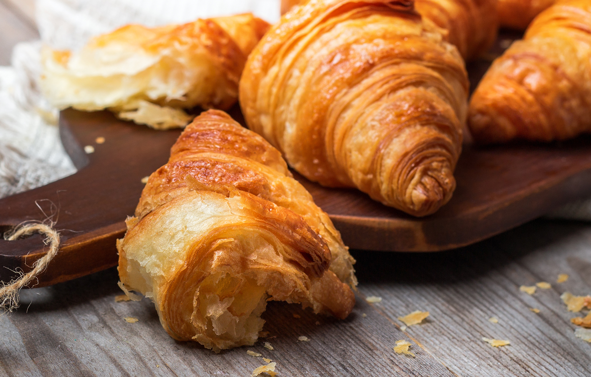 Croissants assorted on wooden platter